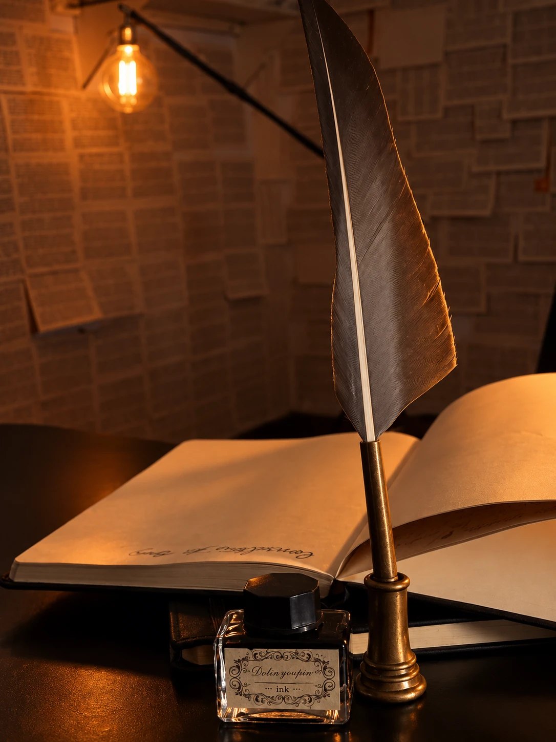 Pena, livro aberto e tinteiro iluminados por uma lâmpada Edison
